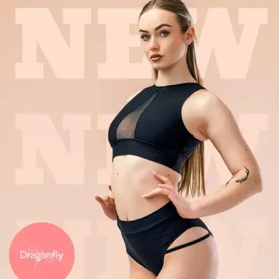 Model showcasing new Dragonfly pole dance outfit, featuring stylish pole shorts and top, perfect for pole wear.